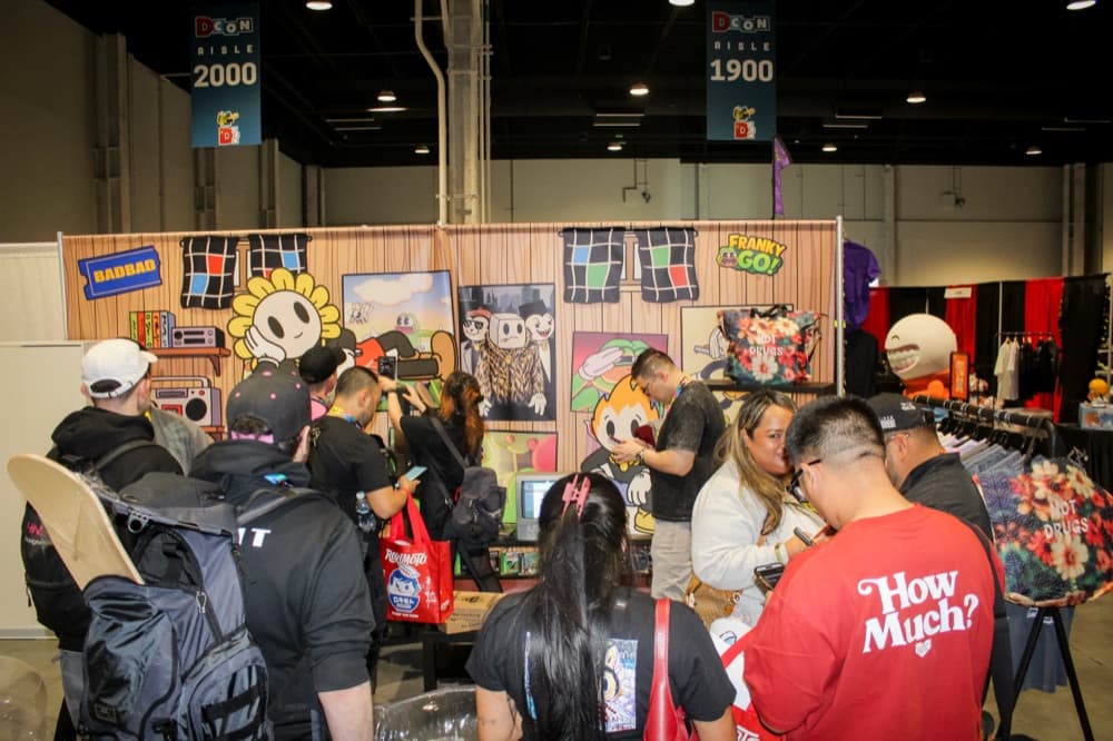 Attendees crowded around a branded booth at DesignerCon